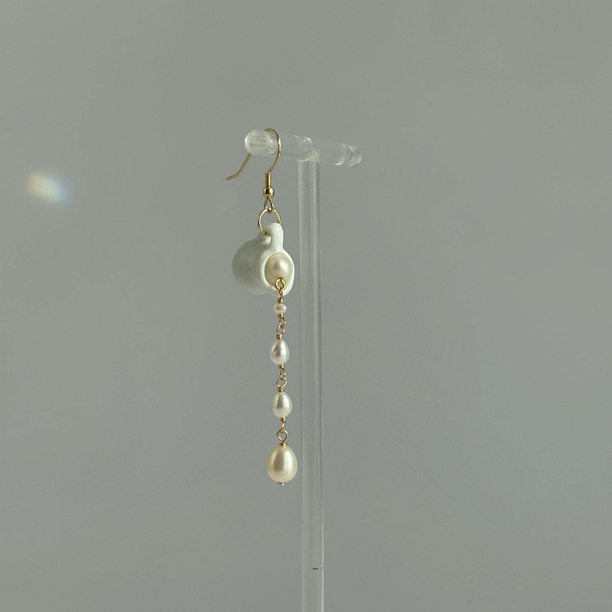 Pearl earrings on a clear stand 