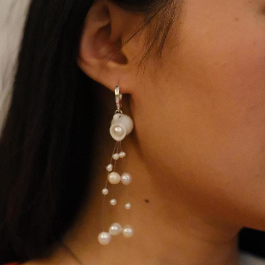 Pearl earring worn by a person 